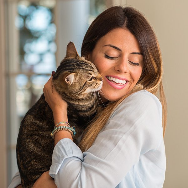 Woman Holding Cat Close Lovingly