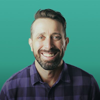 Doctor Moffatt in front of green backdrop